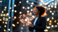 Young African American businesswoman holding sparkler against blurred bokeh lights background, expressing joy and wonder during evening celebration.