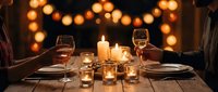 Romantic candlelit dinner for two with wine glasses, candles, and warm bokeh lights on a rustic wooden table, creating an intimate evening atmosphere.