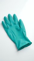 Turquoise rubber protective glove isolated on white background, suitable for cleaning, household chores, healthcare, and safety applications.