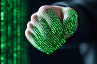 Digital code projection on hand against dark background with green matrix numbers and symbols, representing cybersecurity and technology innovation.