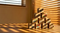 Wooden blocks stacked in pyramid formation with business icons, representing growth strategy, organizational hierarchy, and corporate development planning in warm sunlit office environment.