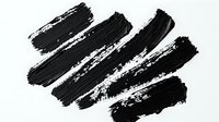 Black diagonal brush strokes with rough textured edges on white background, isolated artistic element for graphic design and creative projects.