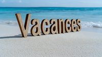 Wooden word Vacances on white sand beach with turquoise ocean water and blue sky background, summer holiday concept for travel agencies and tourism.