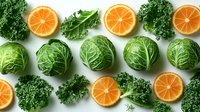 Fresh orange citrus slices with green cabbage heads and kale leaves arranged in geometric pattern on white background. Healthy eating concept.