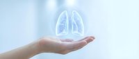 Human hands cupping glowing blue lungs hologram representing respiratory health, medical care, pulmonary wellness and healthcare technology concepts.