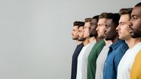 Diverse group of young men standing in profile line showing multicultural teamwork and unity concept for business presentations and social campaigns.