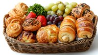 Fresh baked pastries, croissants and sweet rolls in wicker basket with grapes and strawberries, arranged for breakfast or bakery display on white background.