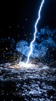 Dramatic lightning bolt striking water surface with bright electric discharge, blue smoke and golden sparks flying against dark stormy background.