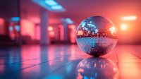 Shiny disco ball reflecting colorful neon lights on dance floor in nightclub with vibrant pink and blue lighting creating party atmosphere.
