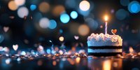 Birthday cake slice with lit candle surrounded by warm bokeh lights and fairy light decorations creating festive celebration atmosphere.