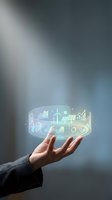 Businessperson holding glowing holographic display with renewable energy, solar panels, wind turbines, and financial growth charts for sustainable business solutions.