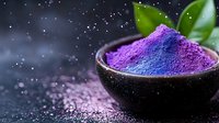 Purple superfood powder in dark bowl with green leaves on starry background for healthy nutrition and wellness supplements.
