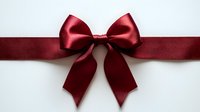 Elegant red satin ribbon bow on white background, perfect for gift wrapping, holiday decorations, wedding invitations and festive celebrations.