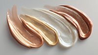 Metallic cosmetic cream swatches in rose gold, gold, pearl white, and bronze shades on white background for beauty product advertising.