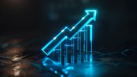 Glowing neon blue arrow chart showing upward trend on dark reflective surface with dramatic lighting, representing business growth and financial success.