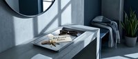 Modern entryway console with keys, sunglasses, and welcome home note on tray, styled in moody blue tones with natural light shadows.