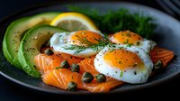 Fresh salmon slices with sunny side up eggs, ripe avocado, capers and dill garnish on dark plate, healthy protein-rich breakfast or brunch serving.