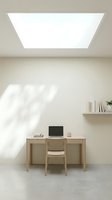 Minimalist home office workspace with wooden desk, chair, and laptop under bright skylight in neutral beige room with floating shelf and natural light.