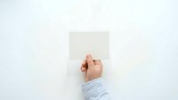 Hand holding blank white card against neutral background, suitable for mockups, presentations, and advertising campaigns.