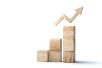 Wooden blocks arranged as ascending stairs with upward arrow showing growth trend, isolated on white background for business concept visualization.
