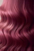 Luxurious wavy burgundy hair texture with flowing curves and highlights creating dynamic movement pattern. Rich wine-colored strands showcase natural shine and depth.