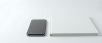 Modern smartphone and laptop computer on clean white surface showcasing minimalist technology design for business and productivity concepts.