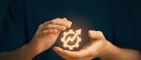 Hands protecting glowing growth arrow symbol representing business success, financial progress and investment protection on dark background.