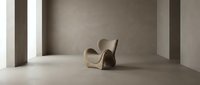 Empty concrete room with modern curved wooden chair and dark sculptural form on polished floor, minimalist interior design space.