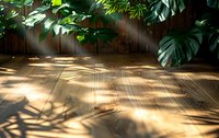Sunlight streaming through tropical leaves creates dramatic shadows on wooden deck flooring, natural lighting effect with monstera plant silhouettes.