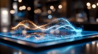 Glowing digital wave particles flow from tablet screen in blue and gold colors creating dynamic motion effect against dark background with bokeh lights.