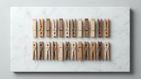 Natural wooden clothespins arranged in neat rows on white marble surface for laundry organization and home decor crafting projects.