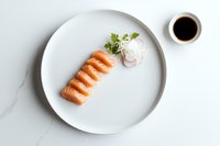 Fresh salmon nigiri sushi arranged in row on white marble plate with soy sauce and garnish, minimalist Japanese cuisine presentation on light background.