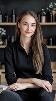 Young Caucasian businesswoman in black shirt smiling confidently at modern office with wine bottles on shelves behind her for hospitality industry.