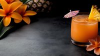 Tropical orange cocktail with pineapple garnish and paper umbrella on dark slate background with plumeria flowers for summer beverage menu design.