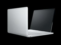 Laptop computer with silver aluminum body and white keyboard, displayed at an angle showing both back and front views, isolated on transparent background ready for t-shirt design, clipart, stickers, and print-on-demand products.