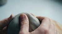 Gentle hands cradling newborn baby head showing tender parental care and protection in soft natural lighting for family and healthcare concepts.