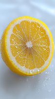 Fresh cut lemon half showing detailed pulp segments and natural juice droplets on white surface, macro photography with selective focus on citrus texture.