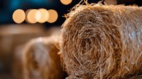 Natural jute rope coils with warm bokeh lights creating rustic craft and DIY project atmosphere for handmade decorations and sustainable materials.
