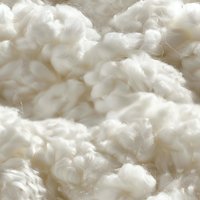 Soft fluffy white cotton fiber macro background with natural raw cotton bolls texture. Seamless pattern for textile and fabric industry designs.