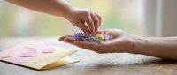 Woman's hands holding colorful pills and capsules over open book on wooden table, healthcare and medication concept for wellness design.