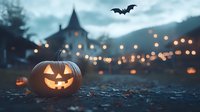 Glowing carved pumpkin with classic smile on dark ground against blurred gothic house and string lights background, flying bat silhouette in moody Halloween evening sky.