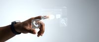 Hand touching digital interface icons including email, phone, and search symbols representing modern communication technology and business connectivity.