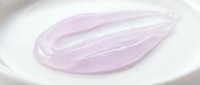 Transparent lavender gel or serum sample on white surface, showcasing cosmetic skincare product texture and consistency for beauty and wellness applications.