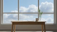 Wooden desk with plant and coffee cup near large window with sky view, suitable for office, workspace, and interior design projects.