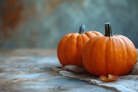 Fresh orange pumpkins on rustic burlap backdrop with soft focus and copy space, seasonal autumn harvest composition for fall decoration.