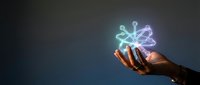 Male hand holding glowing network connection icon with circuit board pattern against dark background, representing digital technology, innovation, and connectivity solutions.