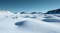 Snow covered mountain landscape with smooth rolling hills creating dramatic shadows against pristine white terrain and clear blue winter sky.