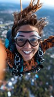 Young Caucasian woman skydiving with protective goggles smiling during tandem jump over scenic landscape below capturing extreme sports adventure thrill.