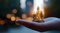 Glowing miniature golden cityscape on open palm against blurred bokeh background, magical urban architecture concept for real estate and city planning.