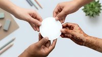 Diverse hands holding blank white circle together in unity, teamwork and collaboration concept for business, community support, partnership and group cooperation projects.
